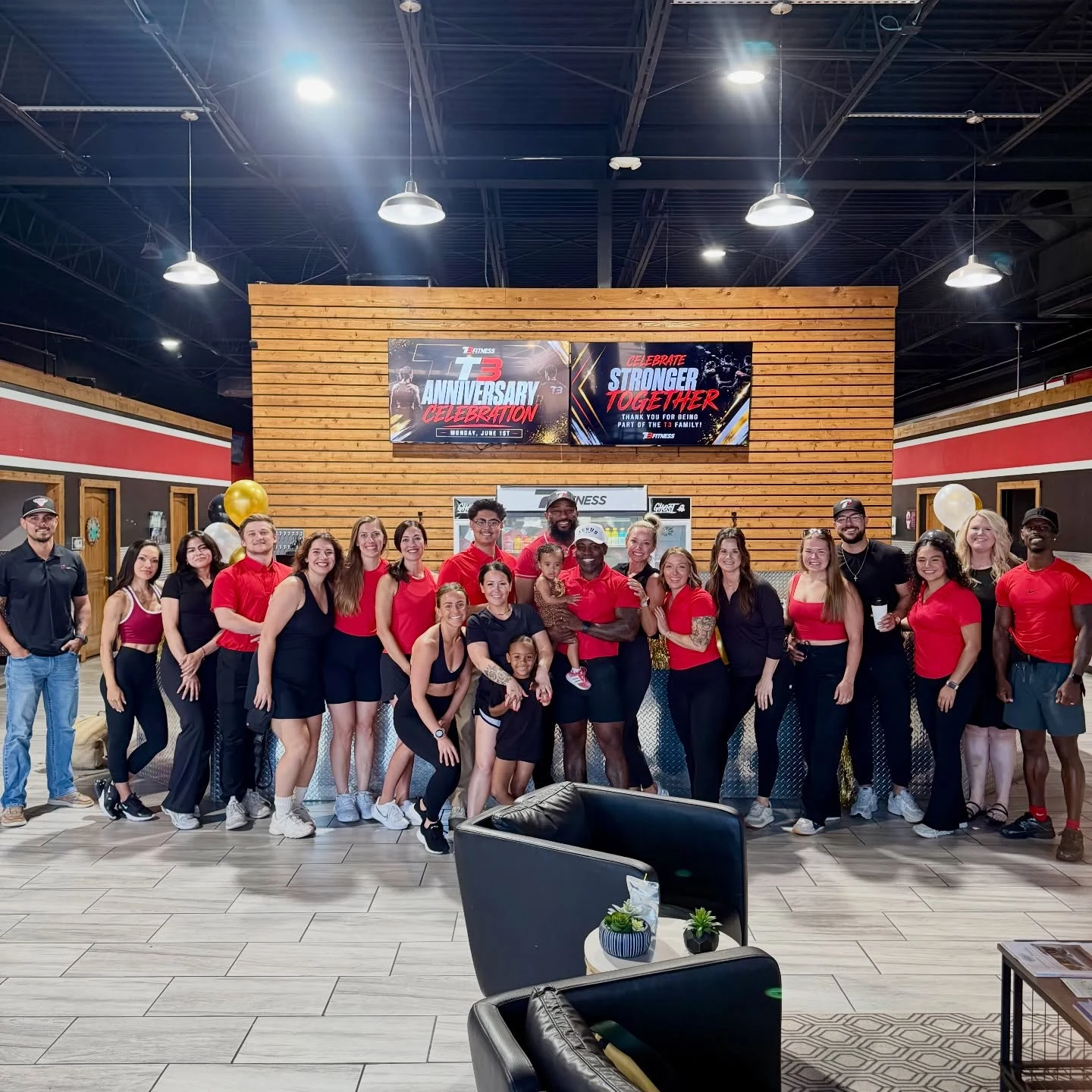 T3 staff gathered at the front desk for their anniversary celebration